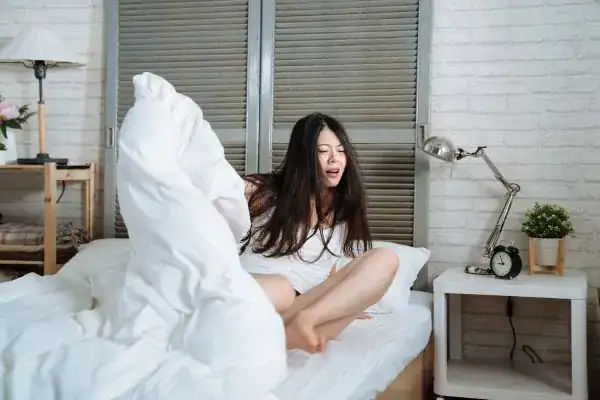 Image of woman getting up because of nighttime leaks Luton